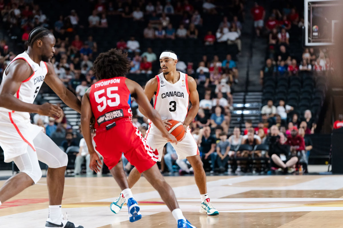 Andrew Nembhard uses a screen from Mfiondu Kabengele during Canada's FIBA Basketball World Cup 2027 Americas Qualifier against Puerto Rico in Hamilton.
