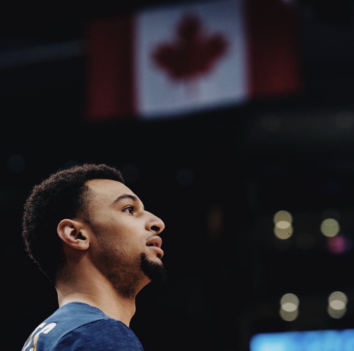 Jamal Murray stands in front of the Canadian flag, representing the country’s growing impact in the NBA Playoffs and inspiring the next generation of Canadian basketball talent.