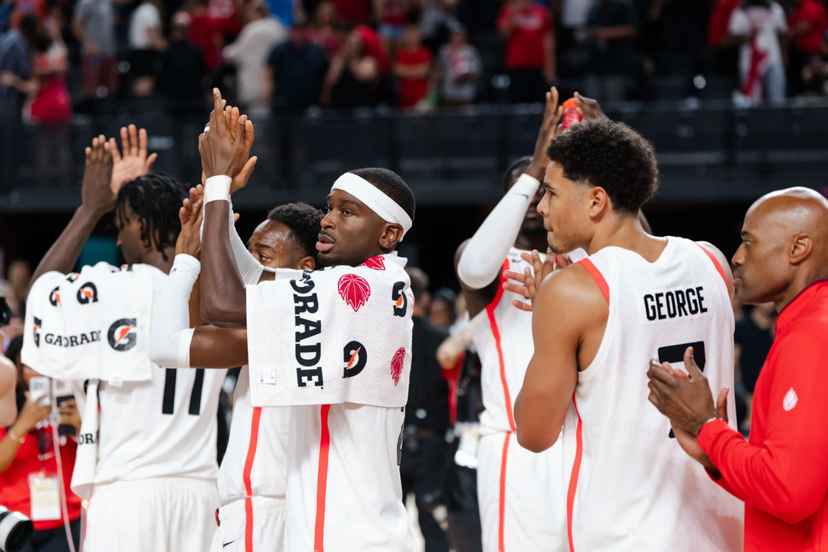 Shai Gilgeous-Alexander, Kyshawn George and Leonard Miller celebrate from the bench as Canada pulls away from Puerto Rico during a FIBA Basketball World Cup 2027 Americas Qualifier.