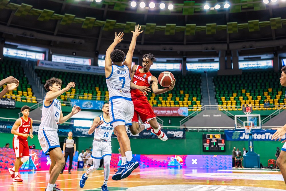 Canadian guard Kamai Samuels drives to the basket and delivers a tasty assist to teammate Paul Osaruyi during the opening game of the 2023 FIBA U16 Americas Championships in the city of Mérida in Yucatán, Mexico.