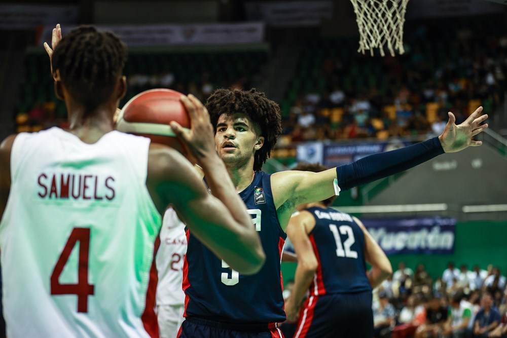 Canadian point guard kamai samuels attempts to inbound the basketball as united states forward cayden boozer applies the full court pressure during the 2023 fiba u16 americas championships