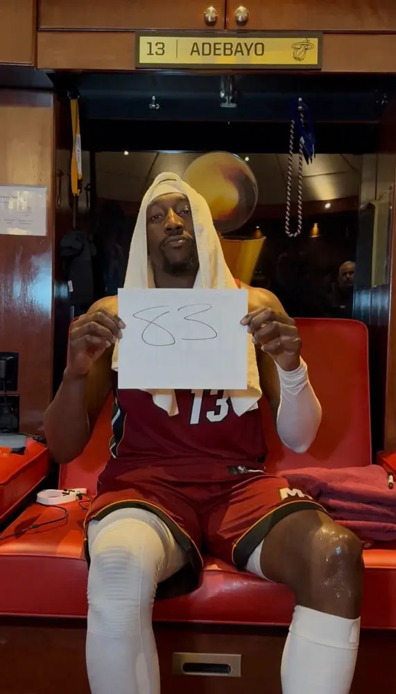 Bam Adebayo holds up an “83” sign in the locker room after delivering the second-highest scoring game in National Basketball Association history for the Miami Heat.