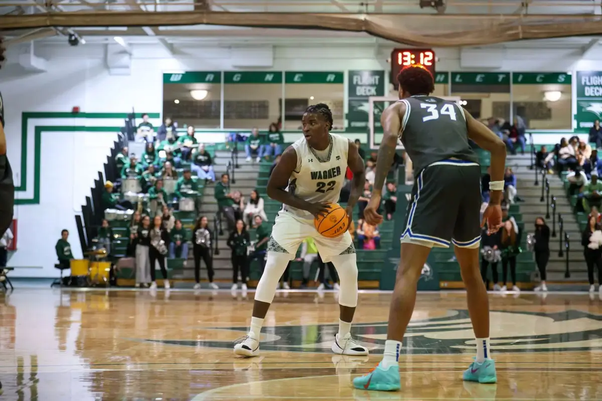 binael basil looking to make pass during wagner basketball