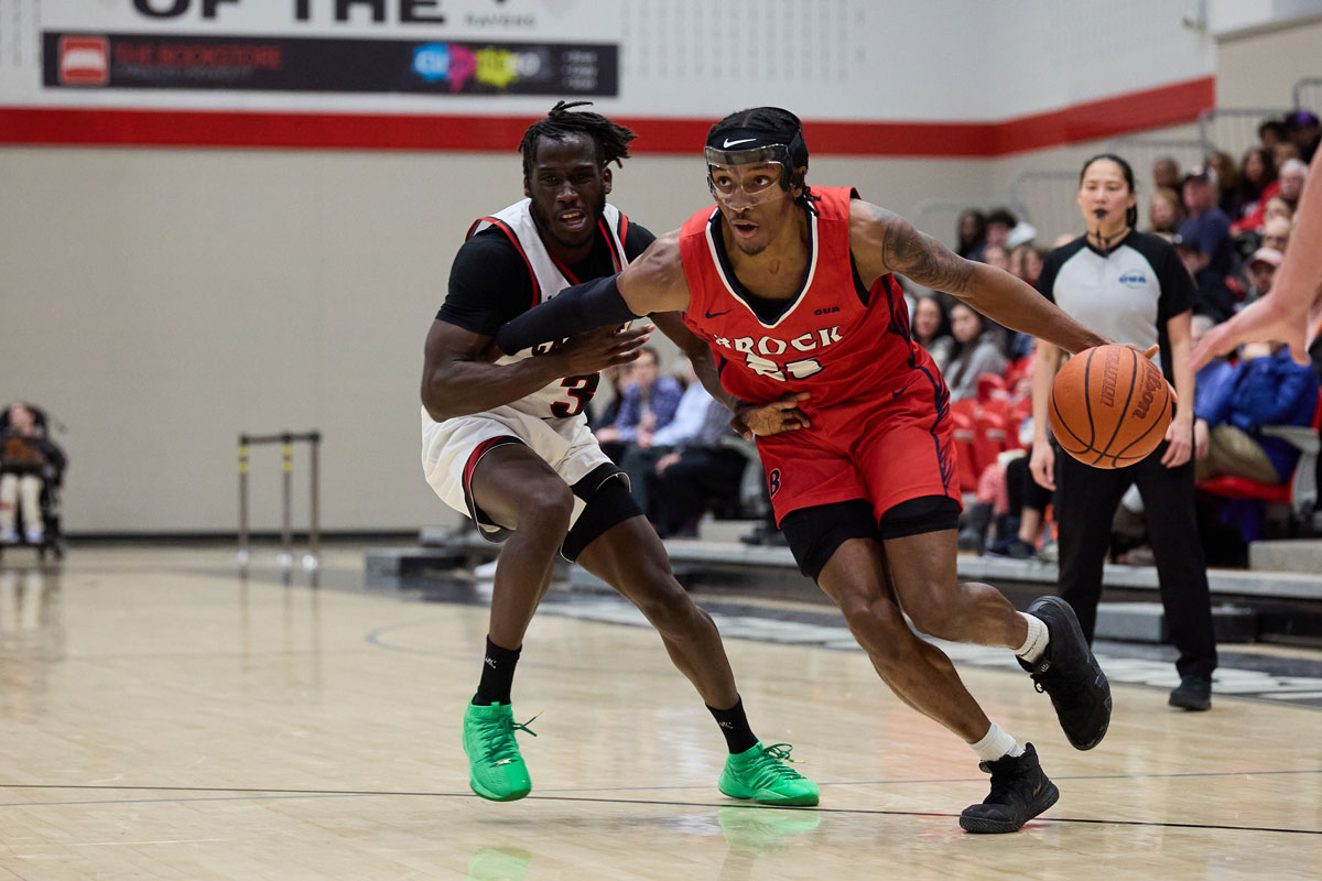 Brock badgers guard jevon brown blows past carleton ravens marjok okado during the opening round of the 2024 oua playoffs