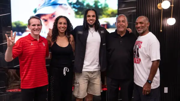 From left to right: Houston assistant coach K.C. Beard, his mother Justine Ellison Sharp, Emanuel Sharp, head coach Kelvin Sampson, and his father Derrick Sharp.