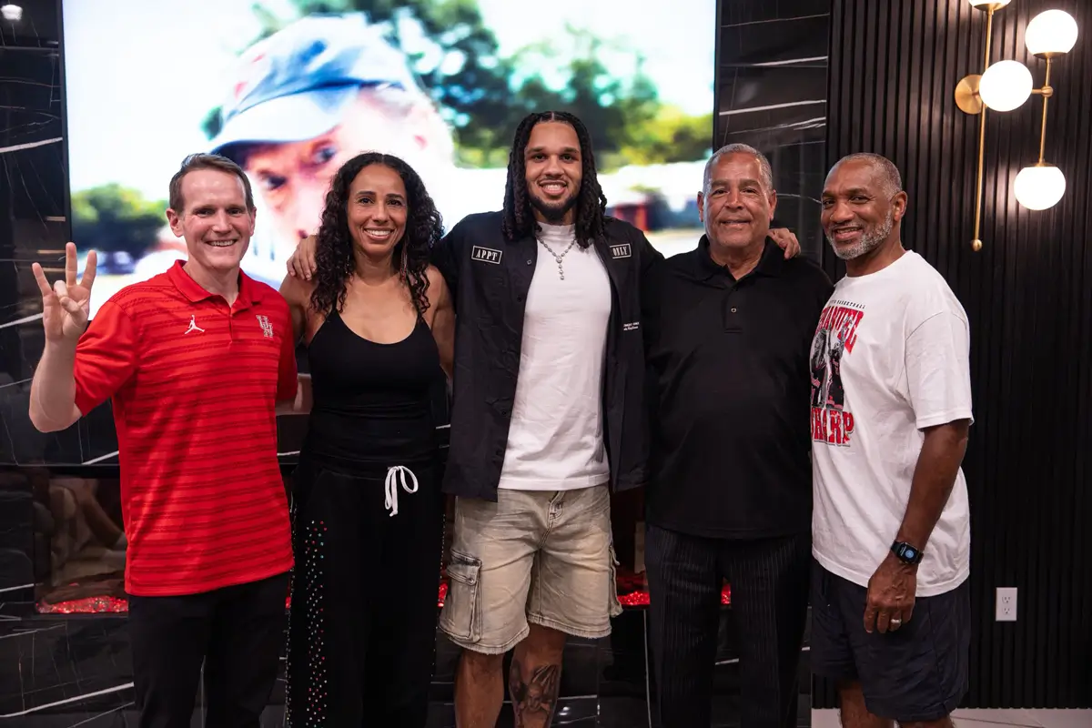 From left to right: Houston assistant coach K.C. Beard, his mother Justine Ellison Sharp, Emanuel Sharp, head coach Kelvin Sampson, and his father Derrick Sharp.