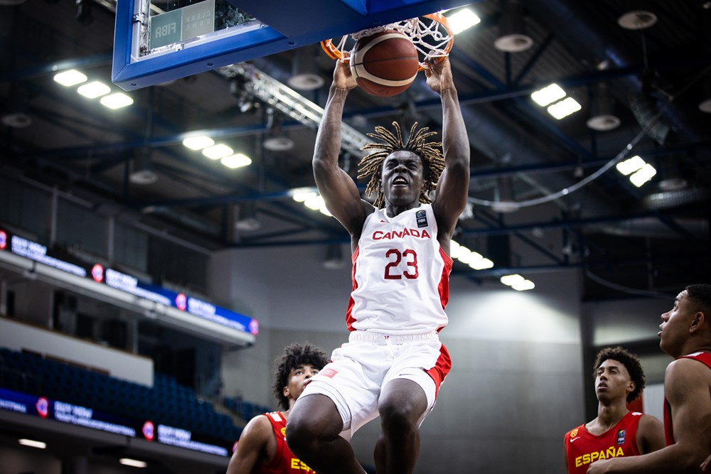Canadian forward michael nwoko slams home a powerful two hand dunk in the 83 56 loss to spain at the 2023 fiba u19 world cup
