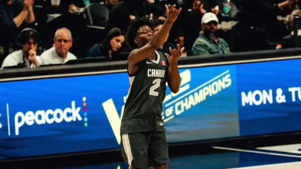 Miles Sadler rises to the moment—celebrating after drilling a clutch three-pointer at the 2026 Nike Hoop Summit, where the Canadian point guard delivered an MVP performance on the global stage.