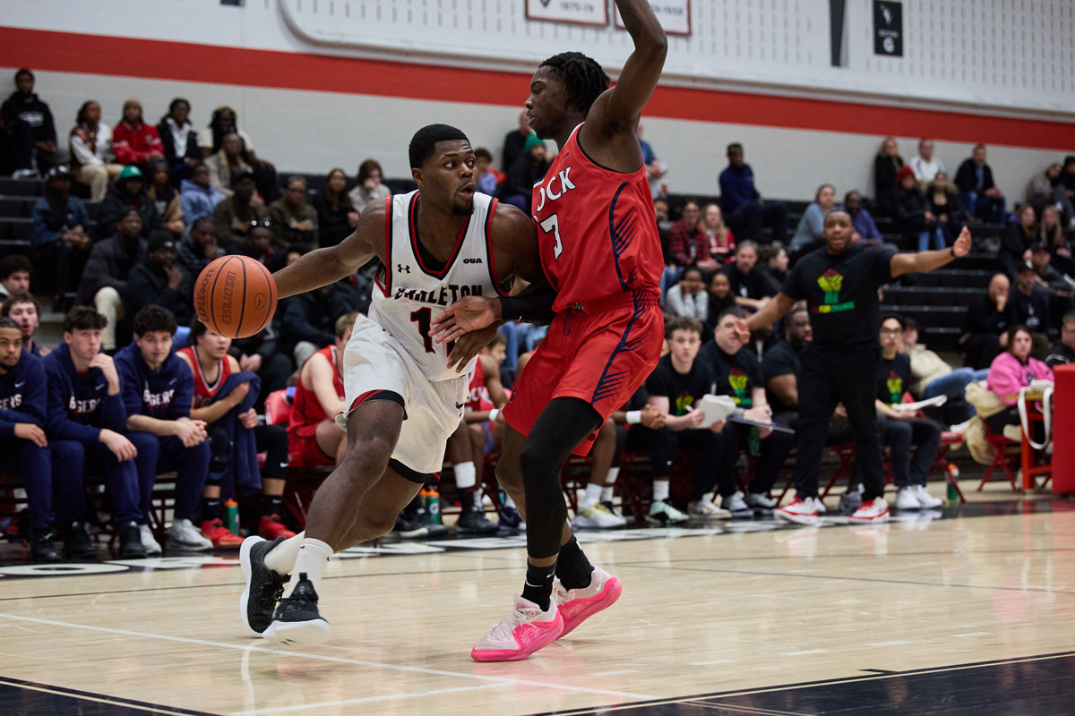 Carleton Ravens freshman point guard Xavier Spencer attacks the rim with a baseline drive against the Brock Badgers. Spencer was named the 2023-24 U Sports Rookie of the year.