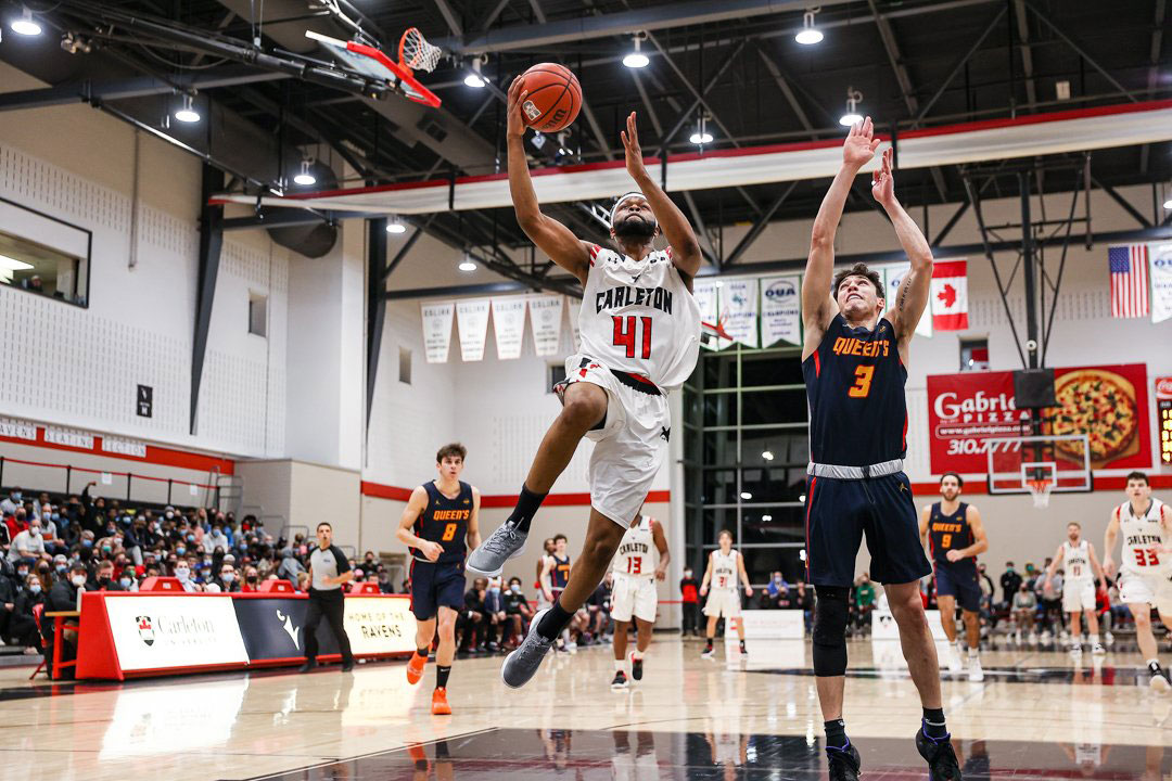 Carleton ravens lloyd pandi goes in for a lay up against the queens gaels 2022 oua basketball semi finals
