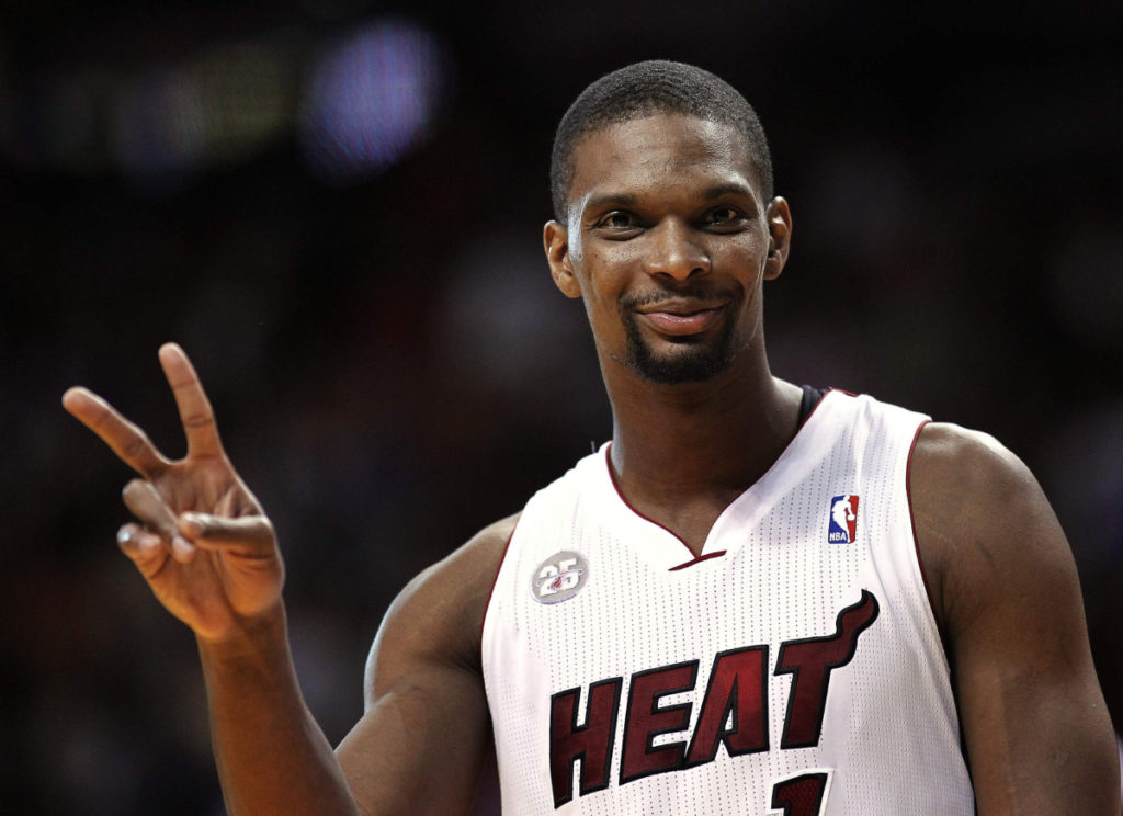 Miami Heat's Chris Bosh gestures after returning to position at the end of a timeout against the Boston Celtics in the second half of their NBA basketball game in Miami, Florida April 12, 2013. REUTERS/Andrew Innerarity (UNITED STATES - Tags: SPORT BASKETBALL)