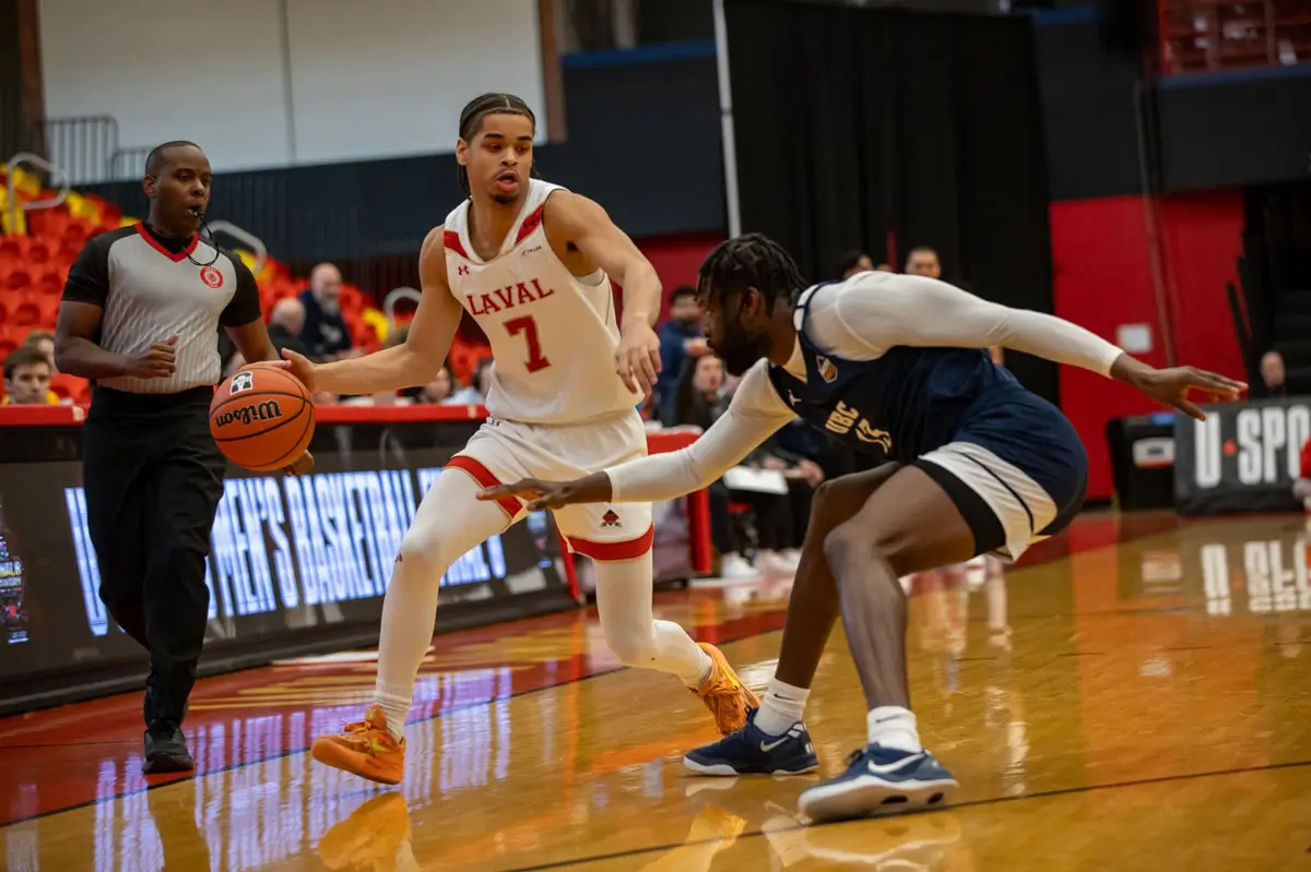 chris tshibola dribbles the basketball against ubc defender at 2026 usports final 8 championship