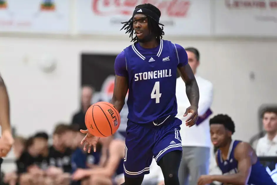 davante hackett stonehill dribbles the basketball during nec conference game
