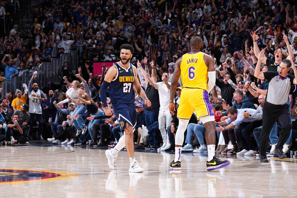 Denver nuggets star guard jamal murray flexes and screams after hitting three pointer over lebron james in game two of the 2023 western conference finals