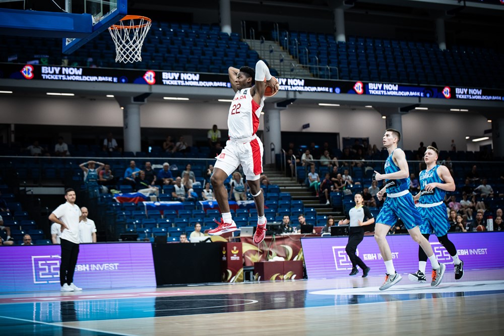 Elijah fisher skies for for two hand slam dunk during canadas victory over slovenia at the 2023 fiba u19 world cup