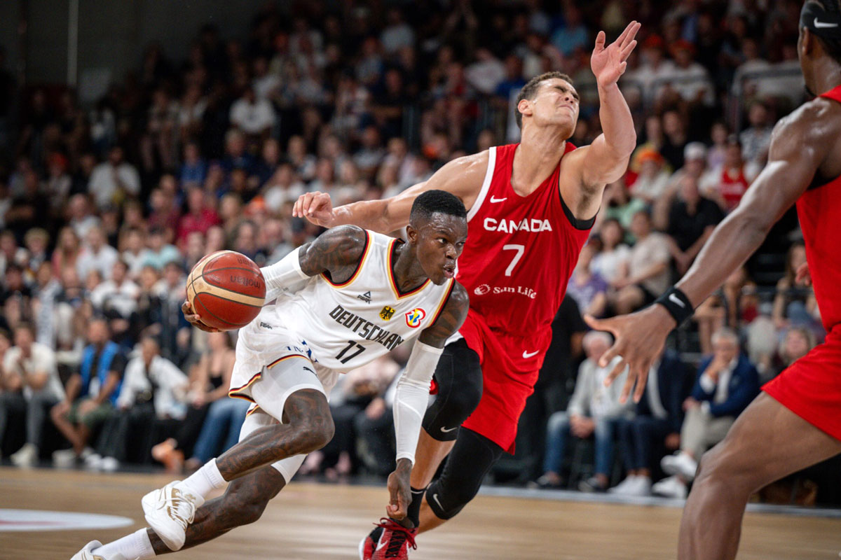 Germany point guard dennis schroder drives past dwight powell during the 2023 dbb supercup