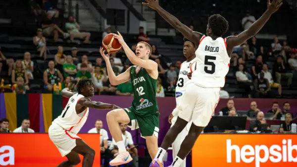 Jokubas Kukta (12) attacks the basket during Lithuania's 103–89 victory over Canada. Kukta finished with 29 points, 10 assists and eight rebounds, narrowly missing what would have been just the second triple-double in FIBA U17 World Cup history.