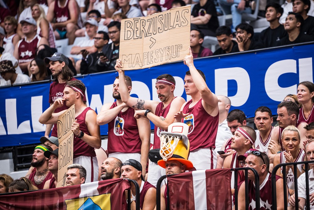 Latvia basketball fans hold up signs in the crowd during canada versus latvia at game the 2023 fiba world cup