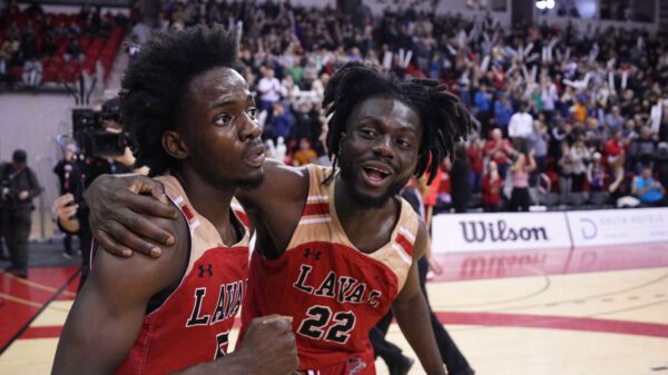 Laval Rouge et Or guard Steeve Joseph (5) celebrates with teammate Baba Yao (22) following the shocking 75-69 win over top-ranked Victoria Vikes at the 2024 U Sports Final 8 Championships at the PEPS sports complex in Quebec City.