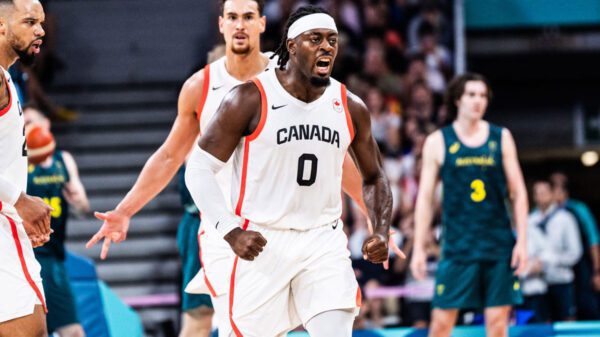 Luguentz dort flexes muscles after hitting a three pointer against australia