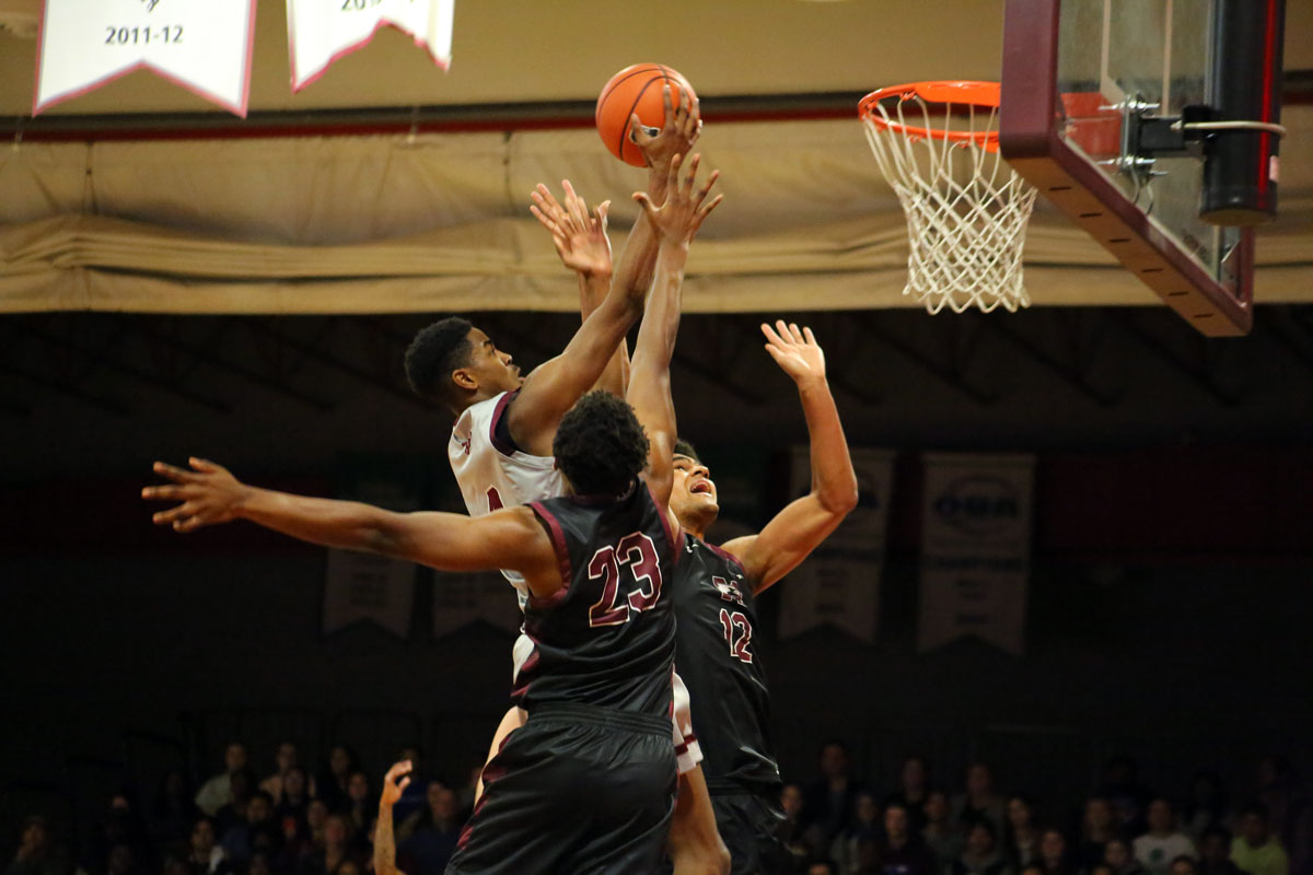 Ottawa gee gees guard quincy louis jeune scores a tough lay up over two mcmaster defenders