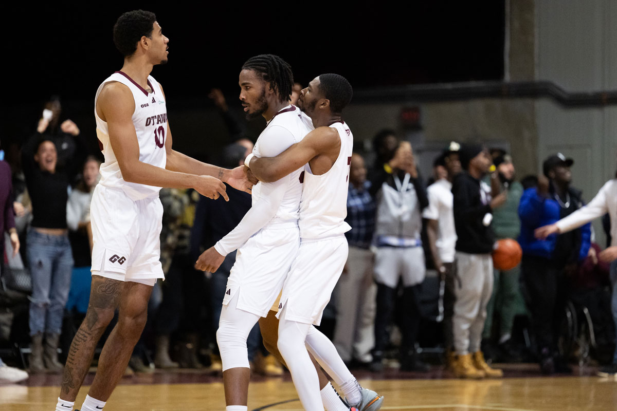 Ottawa gee gees guards kevin otoo and jacques melaine guemeta celebrate following 79 78 win over the carleton ravens