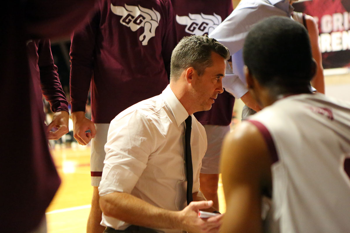 Ottawa gee gees head coach james derouin instructs his players during timeout against the mcmaster marauders