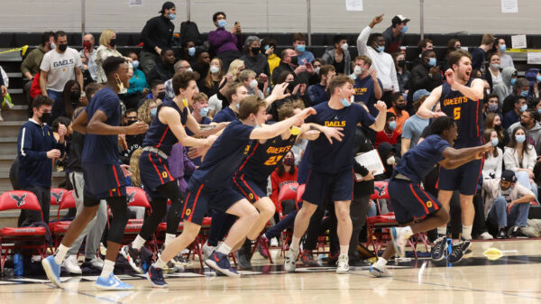 Queens Gaels players celebrate after pulling off a signature 86-80 upset victory over top ranked Carleton Ravens to qualify for first ever U Sports Final 8 championship tournament