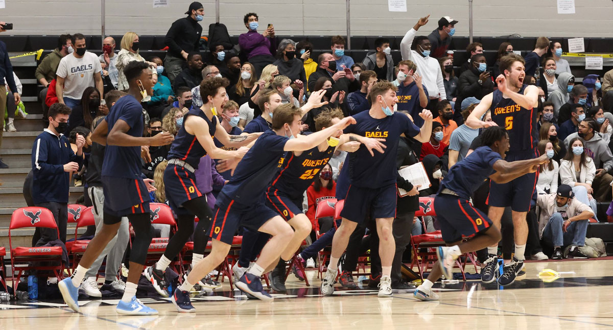 Queens Gaels players celebrate after pulling off a signature 86-80 upset victory over top ranked Carleton Ravens to qualify for first ever U Sports Final 8 championship tournament