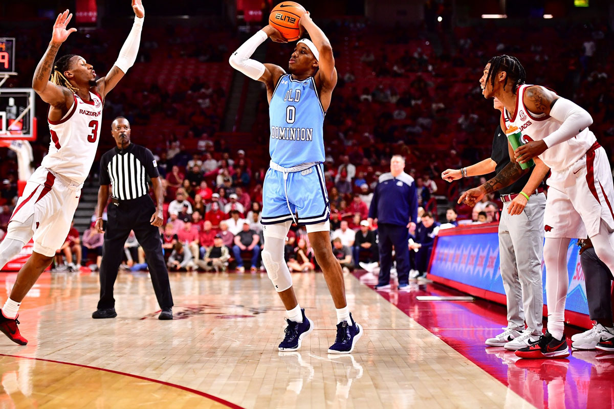 Vasean allette shots a contest three point shot against the arkansas razorbacks