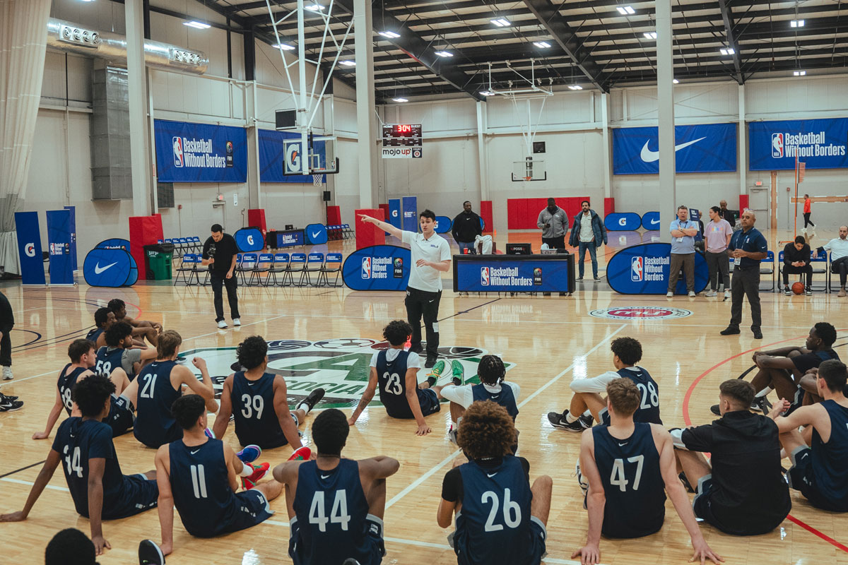 Will riley sitting down and attentively listening at second day of the 2024 basketball without borders global camp