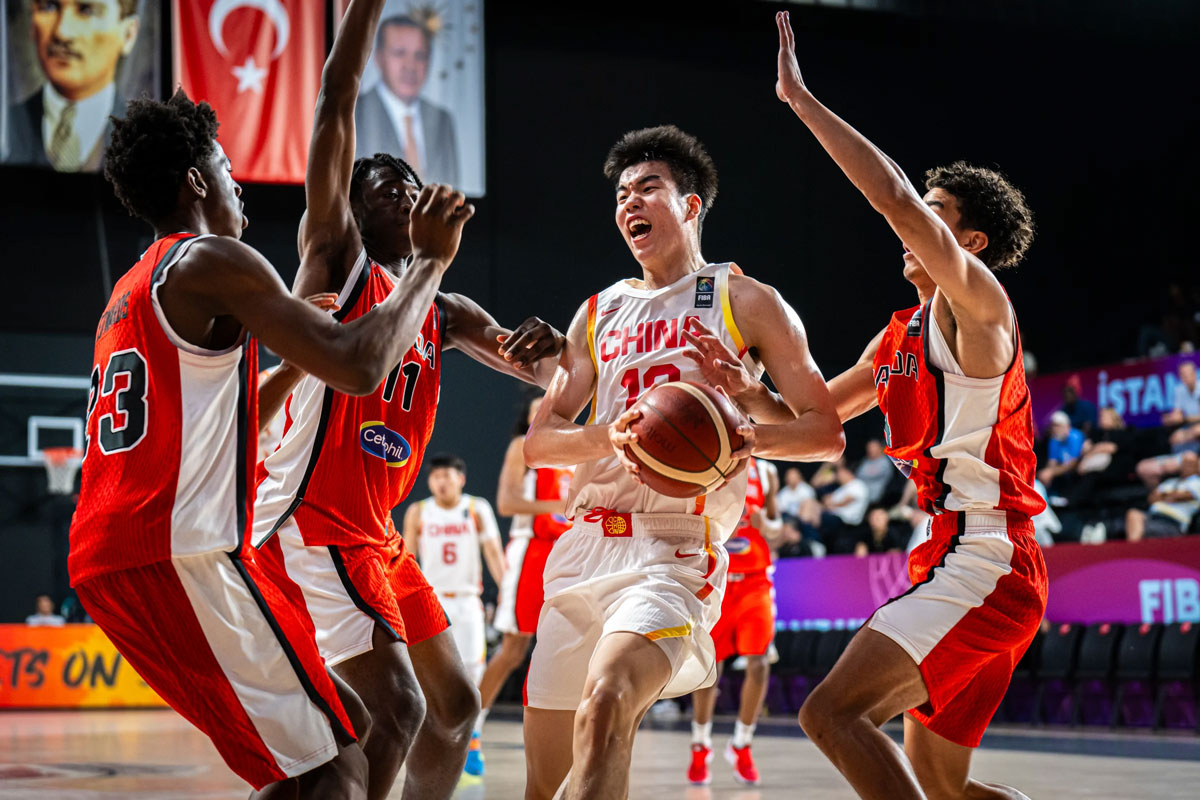 Canada's defense collapses on six-foot-seven Yizhaojie Zhang (13) during the FIBA U17 World Cup. Despite constant pressure, the Chinese forward recorded a game-high 21 points, nine rebounds and three assists in 36 minutes.